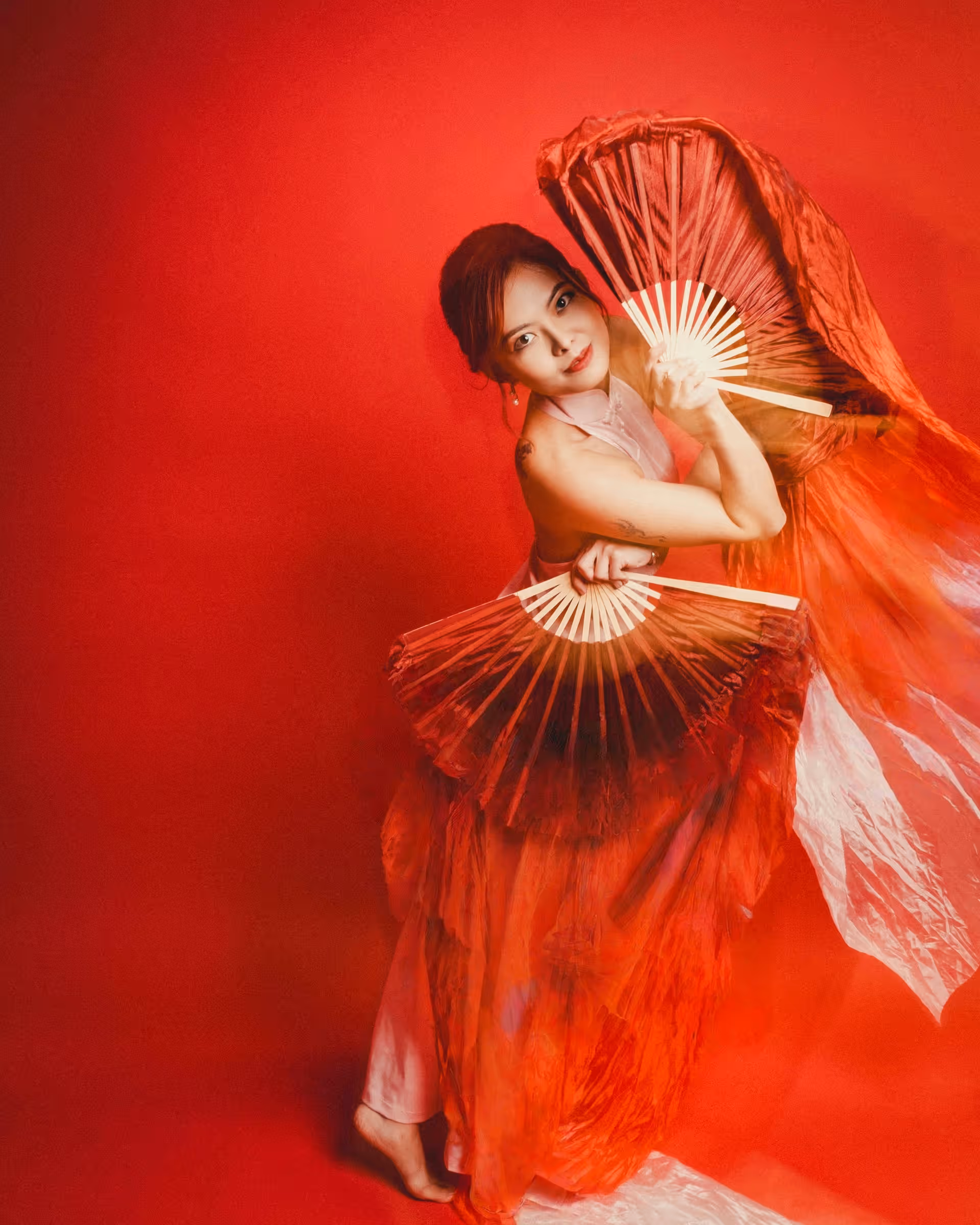 Wanli Wang practicing flow arts with silk fans and sword — frame 4